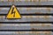 Warning voltage icon on a rusted structure