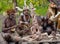 Warrior Asmat tribe sits and carves a ritual statue.