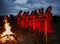 Warriors the Masai tribe dancing ritual dance around the fire late in the evening.