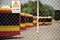 Warsaw city bus depot old rusty fence yellow red buses parked in a row in parking spaces