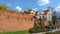 Warsaw Old city. Houses and city wall. Earthworks. Red brick city wall. Small street, Rycerska street, in the medieval old city in
