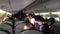 WARSAW, POLAND - DECEMBER, 24. LOT Female flight attendant at work and airliner passengers in the cabin