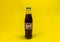 Warsaw Poland - february 22.02.2020. Classic Pepsi glass bottle isolated on yellow background. Pepsi is a carbonated soft drink