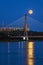 Warsaw, Poland - July 20, 2016: Panoramic view of the rising fullmoon over the National Stadium and Swietokrzyski Bridge