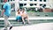 WARSAW, POLAND - JUNE 10, 2017. Young couple sit on the street and use their cellphones