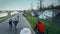 WARSAW, POLAND - MARCH, 27, 2017. Aerial shot of group of young people riding their bikes along evening river embankment