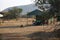 Warthog and motorcycle at a tent in a campground in Pilanesberg National Park