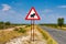 Warthogs crossing warning road sign placed along a road in Namibia