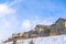 Wasatch Mountain residential area with homes against clouds and blue sky