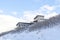 Wasatch Mountain setting with a house on the pristine snowy slope in winter