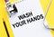 Wash your hands written on notebook. Medical concept