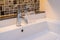 Washbasin with faucet and liquid soap bottle