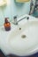 Washbasin with soap accessories/bathroom with washbasin with soap dispenser and cosmetics bottles