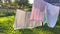Washed clean laundry hanging on the rope or clothesline drying in the wind outdoors