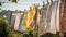 washed clothes hanging on a clothesline in the street on a sunny day. Washday