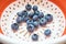 Washed fresh large blueberries in a colander. Berries, healthy food. Close-up. View from above.