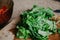 Washed green leaves of arugula lie on cutting board