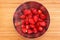 Washed and peeled strawberries in stainless steel bowl