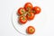 Washed ripe tomatoes group on plate on white background