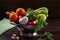 Washed vegetables in a pan on dark background. Rustic Style.