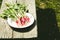 washedup radish in a white bowl/washedup garden radish in a bowl on an old wooden background, top view