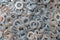 Washers for the bolt. Texture. Many washers for bolts and screws. Background for wallpaper. Shim. Spacer