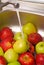 Washing apples fruits in the kitchen