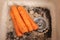 Washing carrot for lunch in a modern kitchen sink. Water rinsing carrot in sink