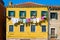 Washing drying on a line strung across the front facade on a brightly painted yellow house in Venice, Italy
