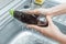 Washing eggplant under a stream of water