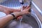 Washing hands properly with splashing water. Hygiene concept. High angle