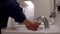 Washing hands in a public toilet