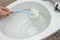 Washing inside the toilet bowl with a disinfectant