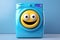 Washing machine with big yellow smiling face on the front loading door. Appliances for home or public laundry