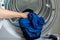 Washing machine for clothes, woman hand loads tumble dryer and tumble dryer