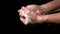 Washing male hands with soapy foam closeup on a black background