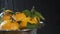 Washing orange tangerines with water drops on black background