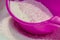 Washing powder and pink measuring spoon