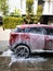 Washing red car with active foam