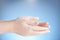 Washing teenager hands isolated on blue background