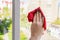 Washing windows. Woman sprays a detergent and wipes the glass. Home cleaning concept