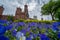 Washington, DC - May 11, 2019: Exterior view of the Smithsonian Castle, with purple pansies flowers in foreground