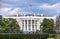 Washington DC, USA. White House view on cloudy day background and american flag.