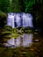 Washington State waterfall with mossy rocks glossy pond