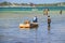 Wasini island, Kenya, AFRICA - February 26, 2020: Men and ships and small boats on the water on wild island. It is the