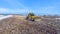 Waste disposal dump. The bulldozer pushing the waste at the dump. Drone. 4K.