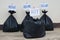 Waste management , black plastic bags that contain garbage inside