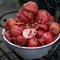 Waste from pomegranate fruit without grains in enamel bowl after juicing with mechanical juicer