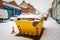 Waste recycling skip on british street under winter snow fall in england uk