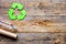 Waste recycling symbol with garbage on wooden background top view mock-up